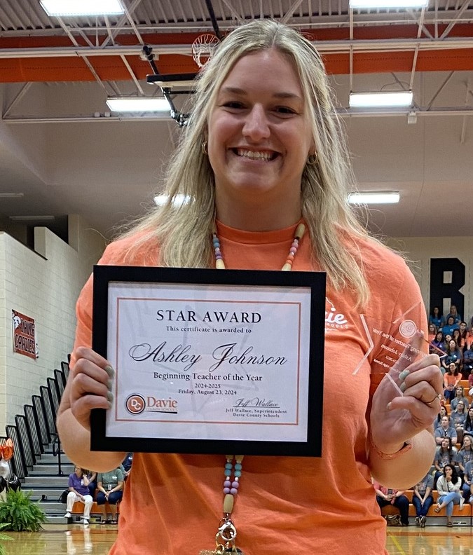 Ashley Johnson holding her certificate for Beginning Teacher of the Year