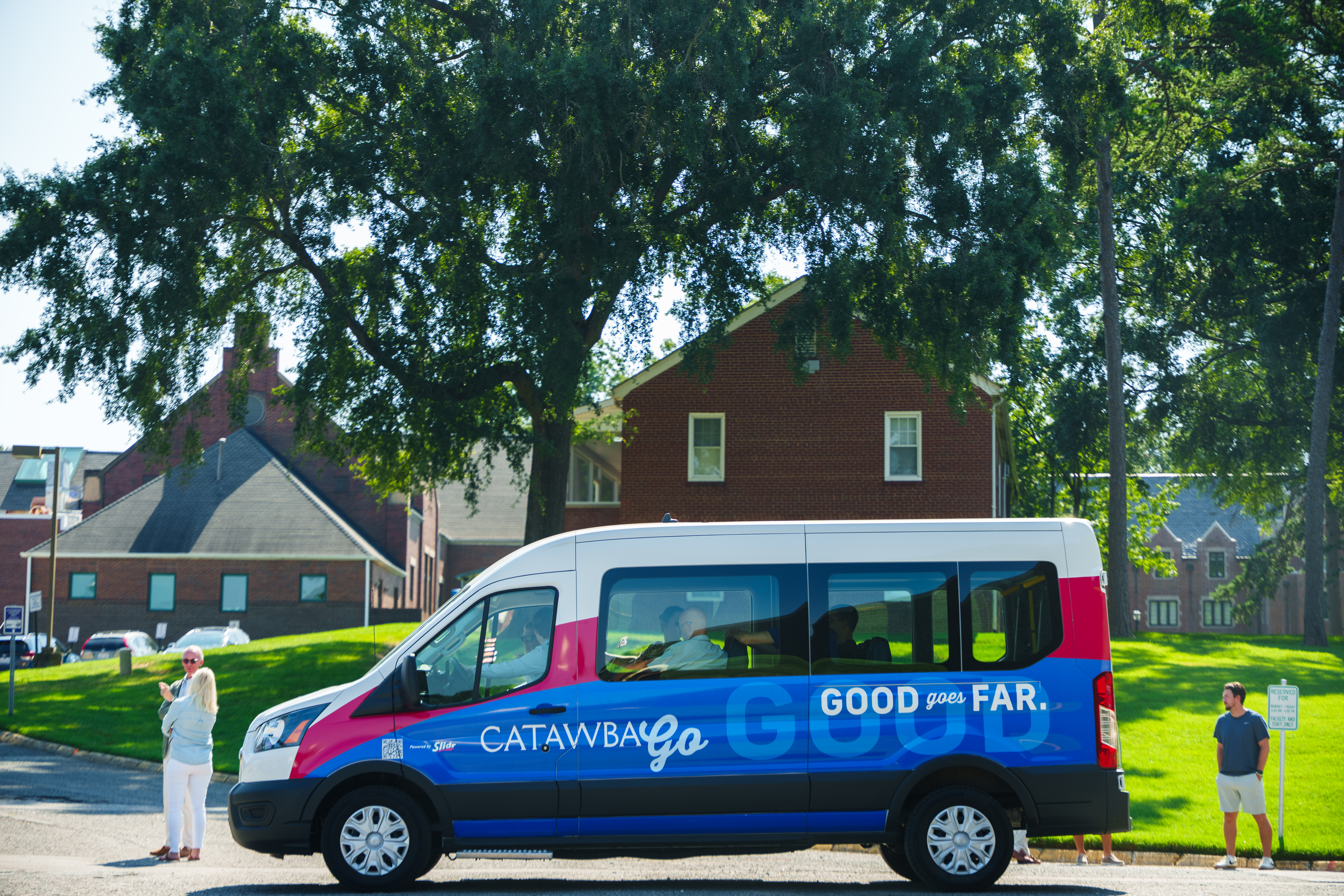 CatawbaGO van on campus with people around it outside & sitting inside