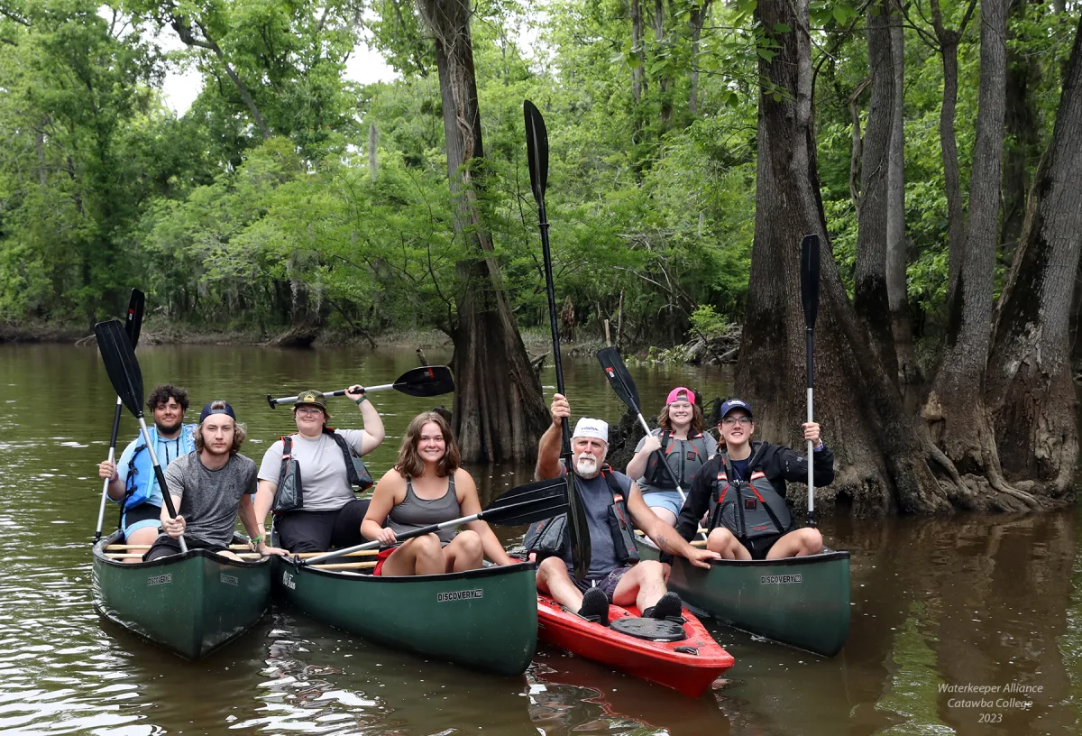 Students sit in canoes as part of the Clean Water Bootcamp