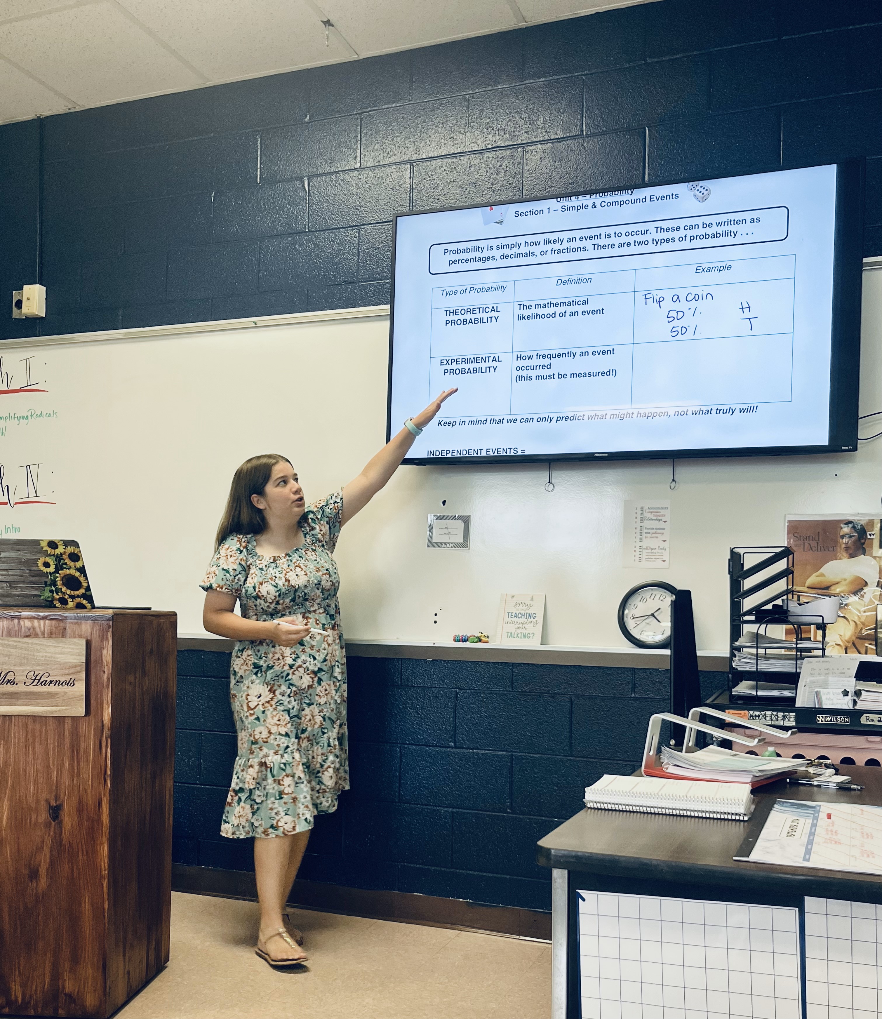 Abigail Hartsoe Harnois at a whiteboard teaching