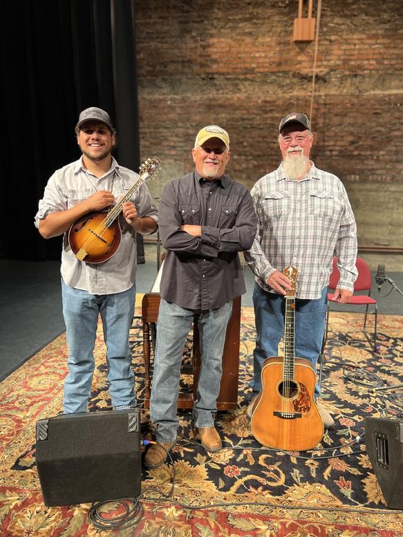 Members of the Jeff Little Trio band pose with instruments