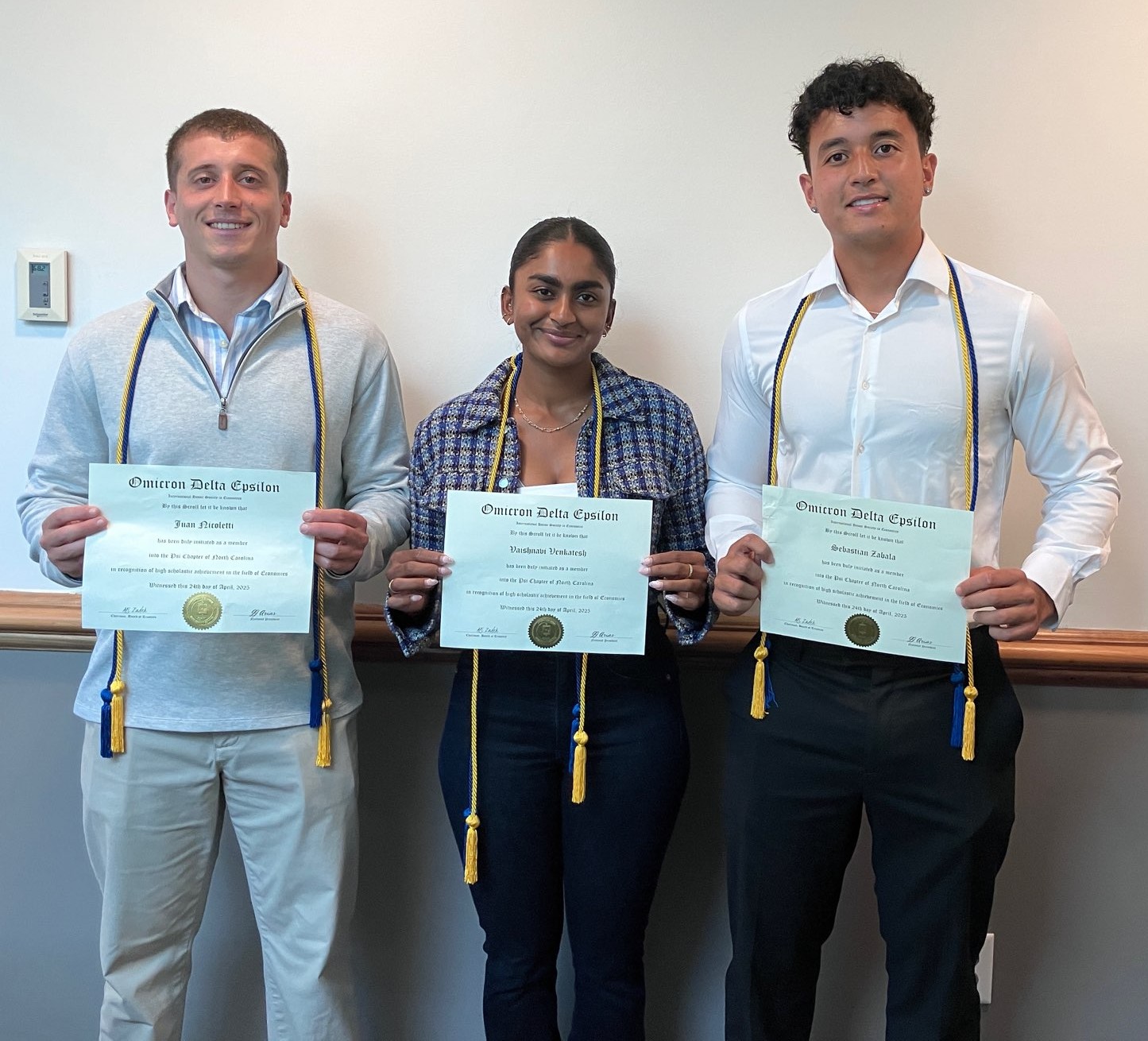 Three members inducted into the Omicron Delta Epsilon Chapter