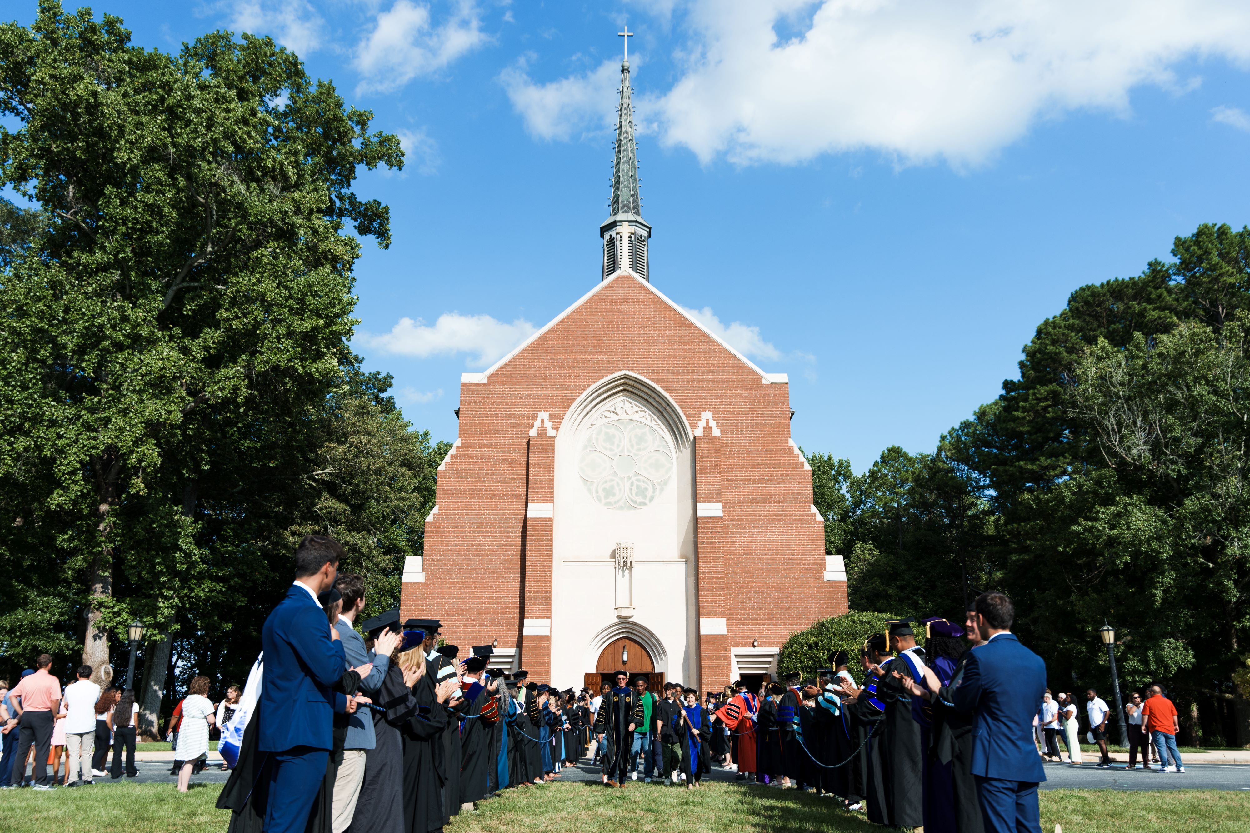 President Nelson leads new students through a line up of Catawba faculty out of the Chapel