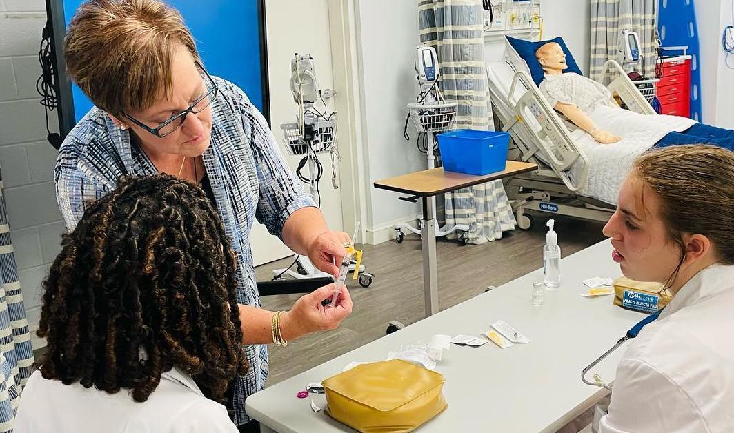 Nursing faculty doing a demonstration for students