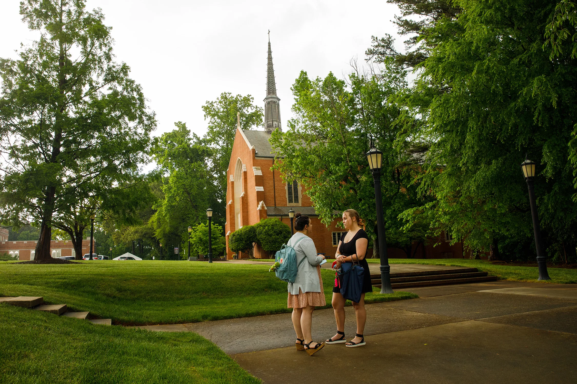 Students talking outside with chapel in background