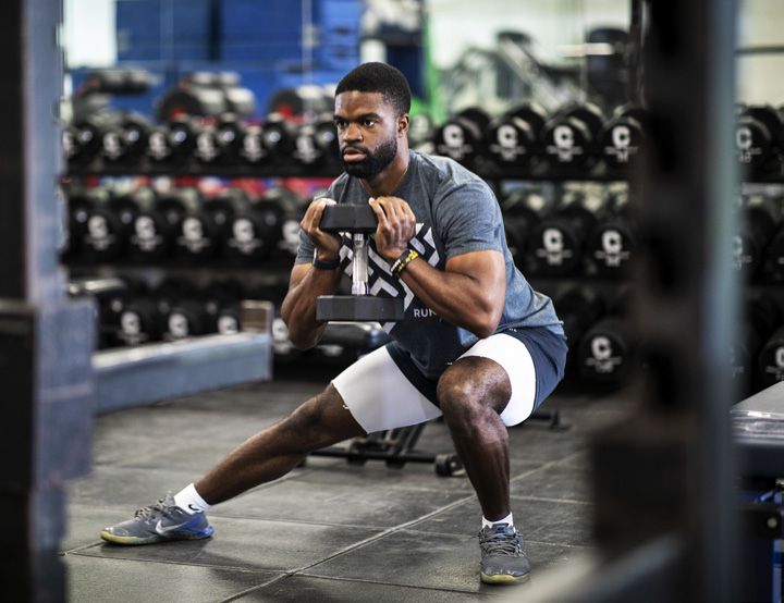 Student weight training with a dumbbell